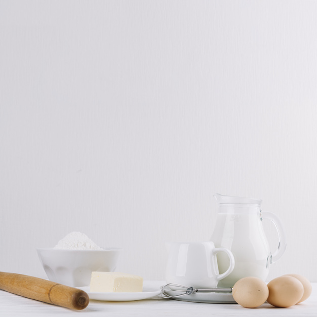 cheese-flour-milk-rolling-pin-whisker-eggs-white-backdrop-making-pie_23-2147972698